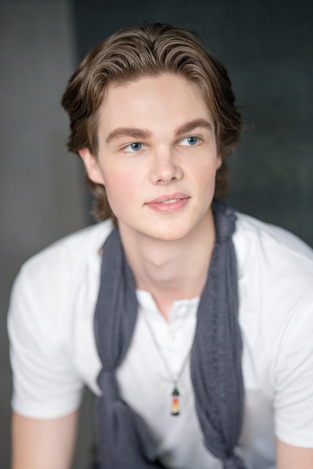 Deric Bucher headshot, white shirt and scarf