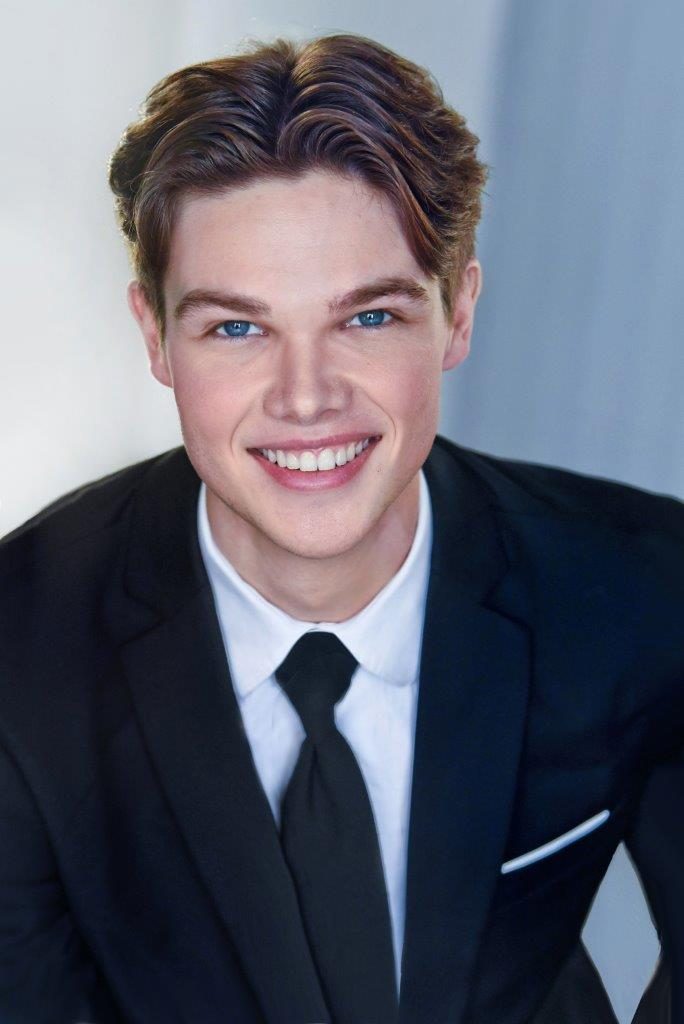 Deric Bucher headshot, black suit