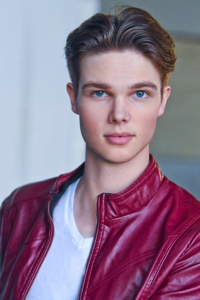 Deric Bucher headshot, red leather jacket